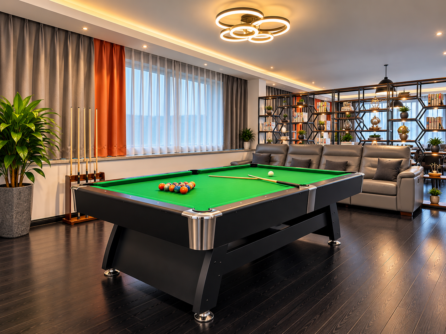 A billiards table, sofa and bookshelves in a recreation area